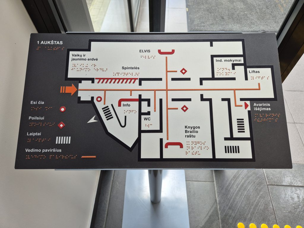 A tacktile map, i.e. a floor plan of the 1st floor on a stand, designed for both touch and sight.